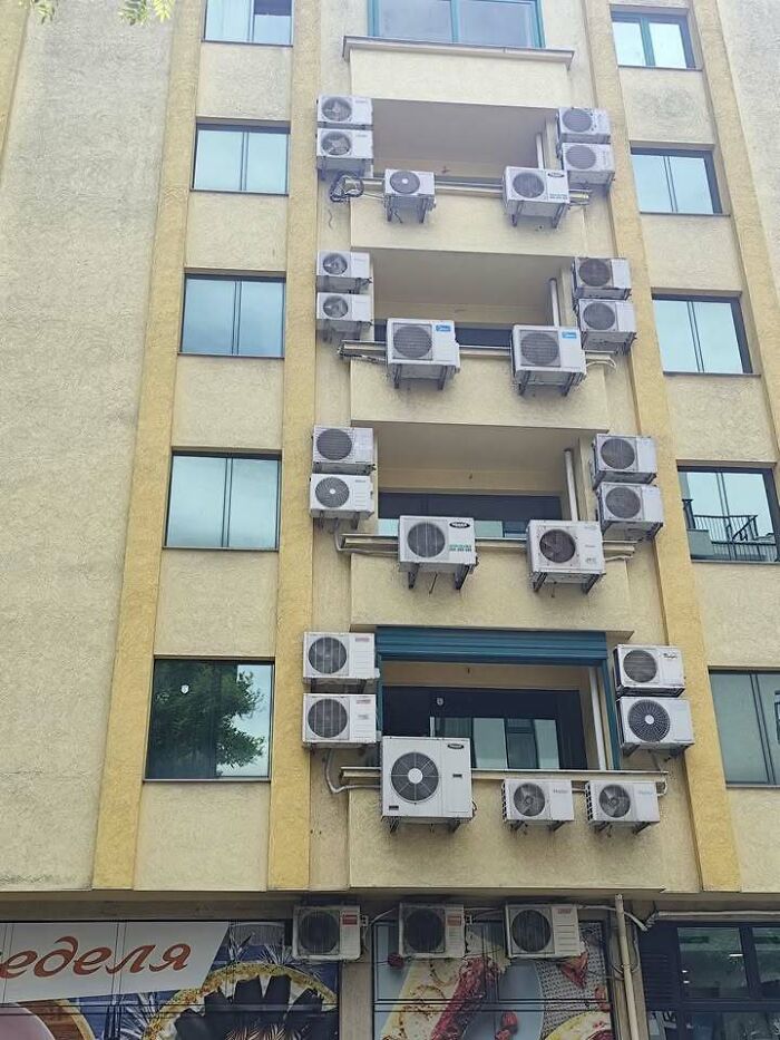 A building in Eastern Europe covered with numerous air conditioning units, highlighting unique engineering and local solutions.