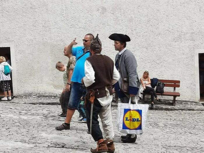 A meme of people from Eastern Europe with modern and historical dress, one carrying a Lidl bag.