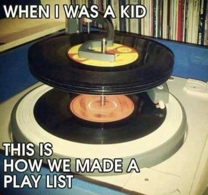 A vintage record player with stacked vinyl records, illustrating how Gen X made playlists.