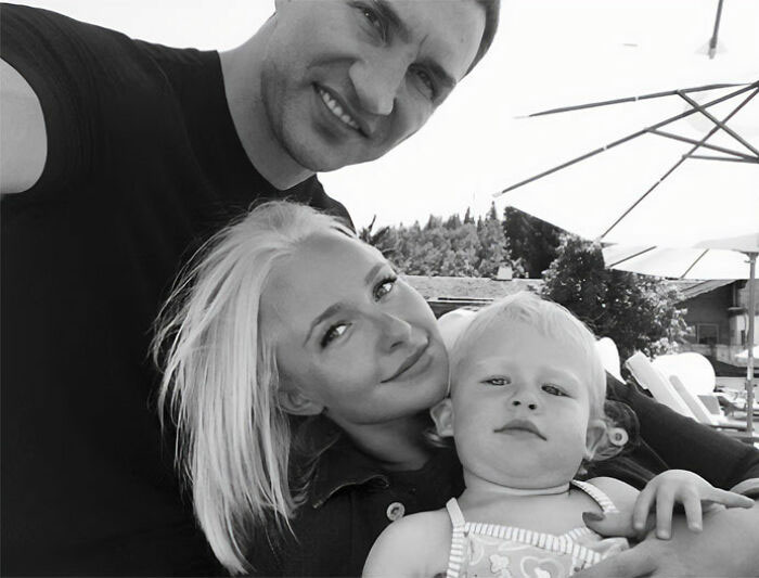 Black and white selfie of Hayden Panettiere with her family, including a man and a child. Black and white selfie of Hayden Panettiere with her family, including a man and a child.