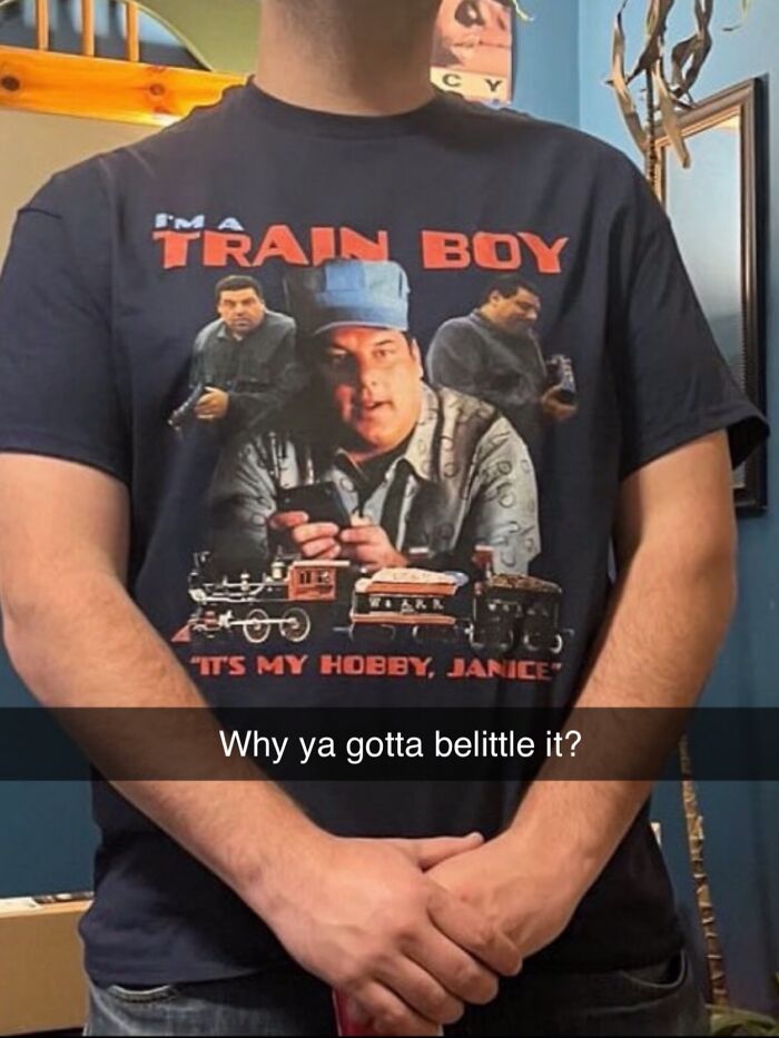 A person wears an iconic shirt with a man next to a train, text says 'I'm a train boy, it's my hobby, Janice.'