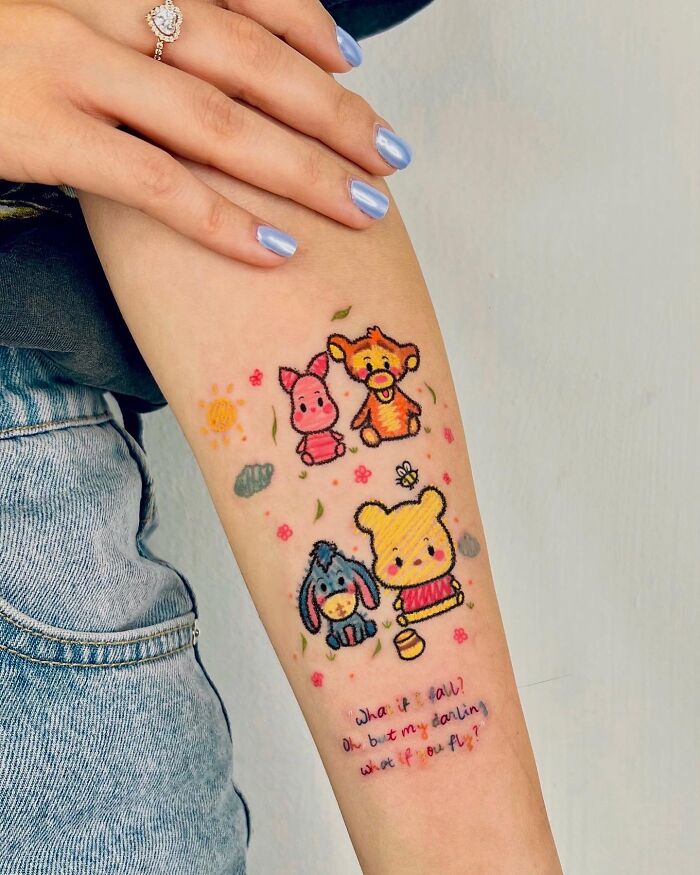 Crayon drawing inspired tattoos of Winnie the Pooh, Piglet, Tigger, and Eeyore with a quote.