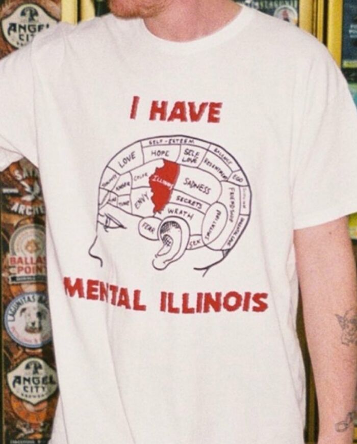Iconic shirts: Close-up of a person wearing a white t-shirt with a brain diagram and text 'I HAVE MENTAL ILLINOIS'.