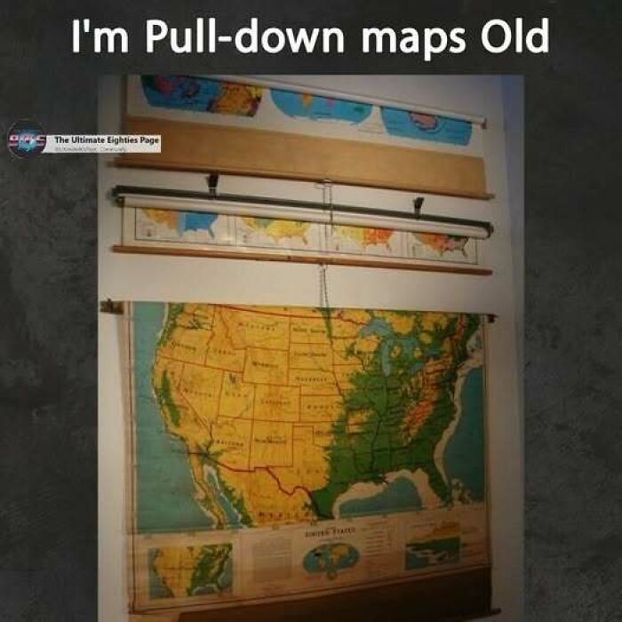 A classroom with several pull-down maps of the USA, reminding viewers of the good old days of the '80s.