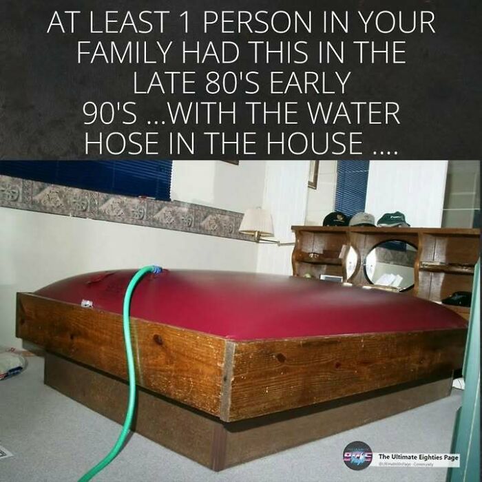 A waterbed being filled with a hose in a bedroom, representing a common 80s household item.
