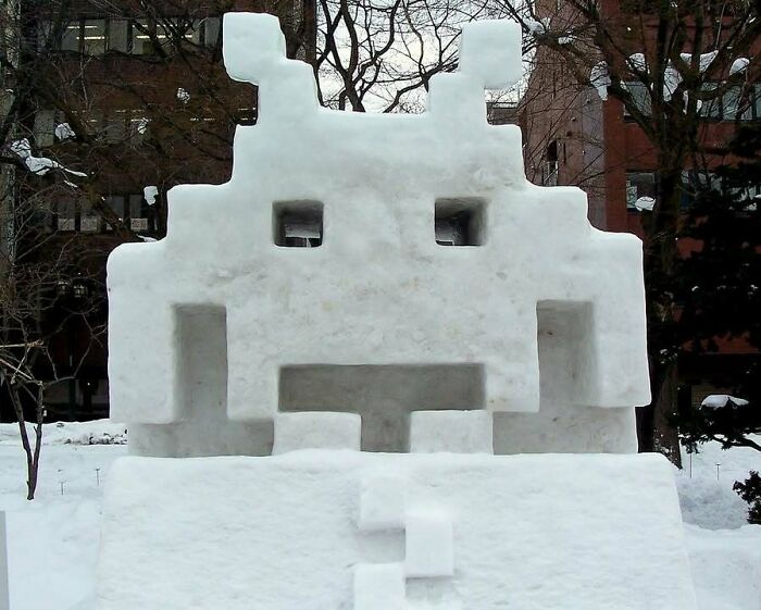 An impressive snow sculpture of a pixelated alien from the classic '80s video game Space Invaders.