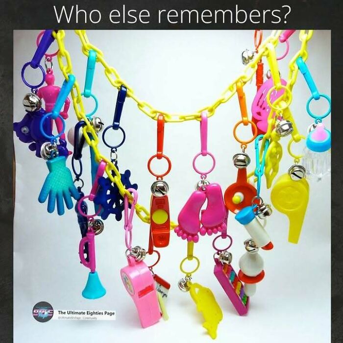 A vibrant collection of colorful plastic keychains from the '80s, including whistles, hands, and feet, evoking good memories.