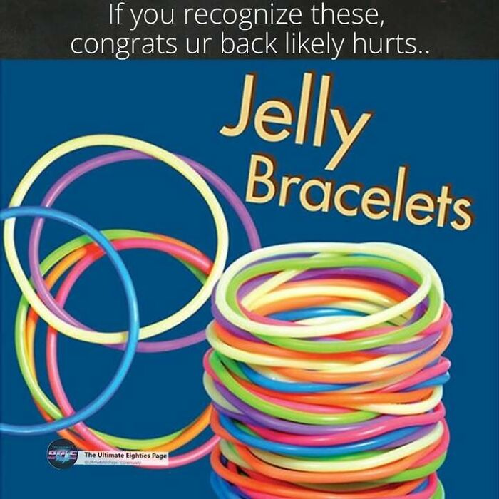 A pile of colorful jelly bracelets, a popular fashion accessory from the '80s, on a blue background.