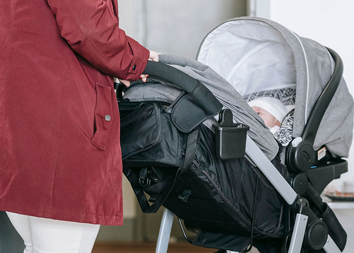 A person pushing a baby stroller, representing a potential unexpected outcome of a first date.