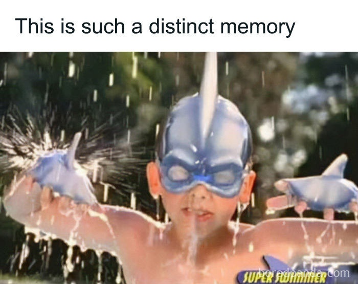 A child in shark-themed water toys, creating nostalgia for those who experienced the magic of the 90s and 00s.