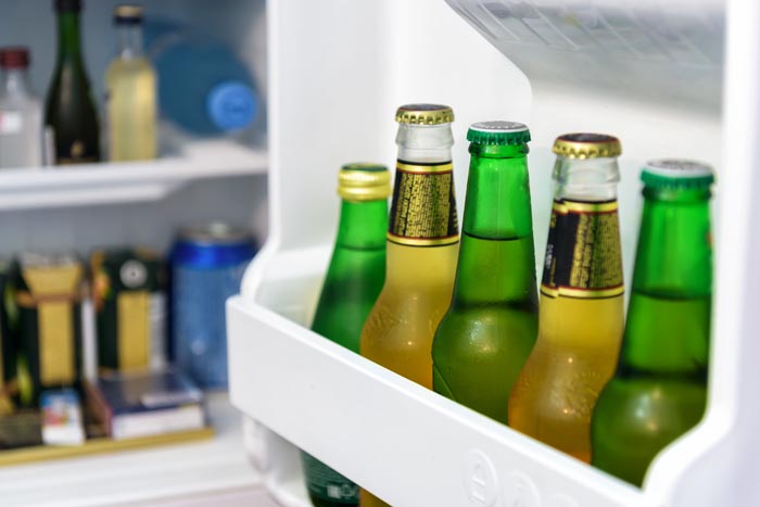 Beer bottles chilling in a refrigerator, possibly related to dumb work rules.