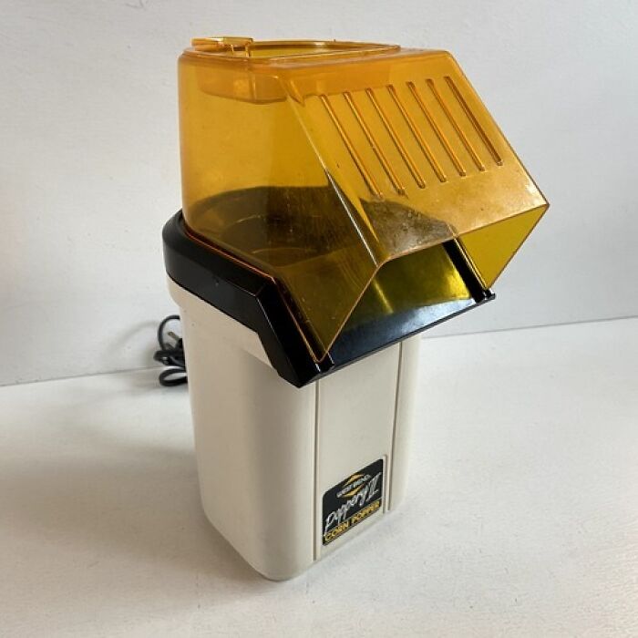 A vintage yellow and white popcorn popper from the 80s, reminding us of good times and how old we become.
