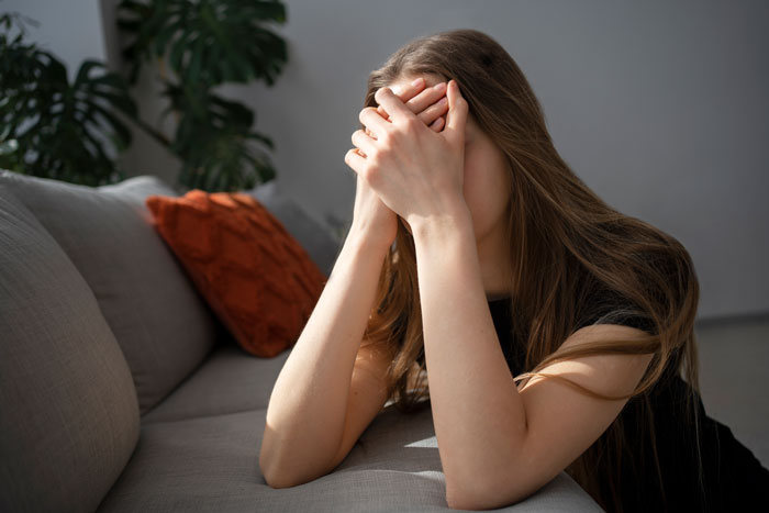 A distressed woman covers her face, revealing her boyfriend's family's cruel plan to upset her. A distressed woman covers her face, revealing her boyfriend's family's cruel plan to upset her.