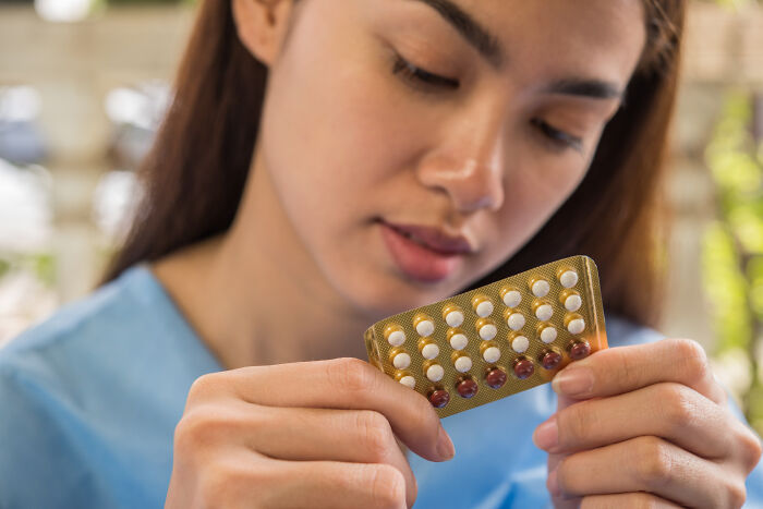 A woman holds a pack of birth control pills, an example of things doctors refuse to do.