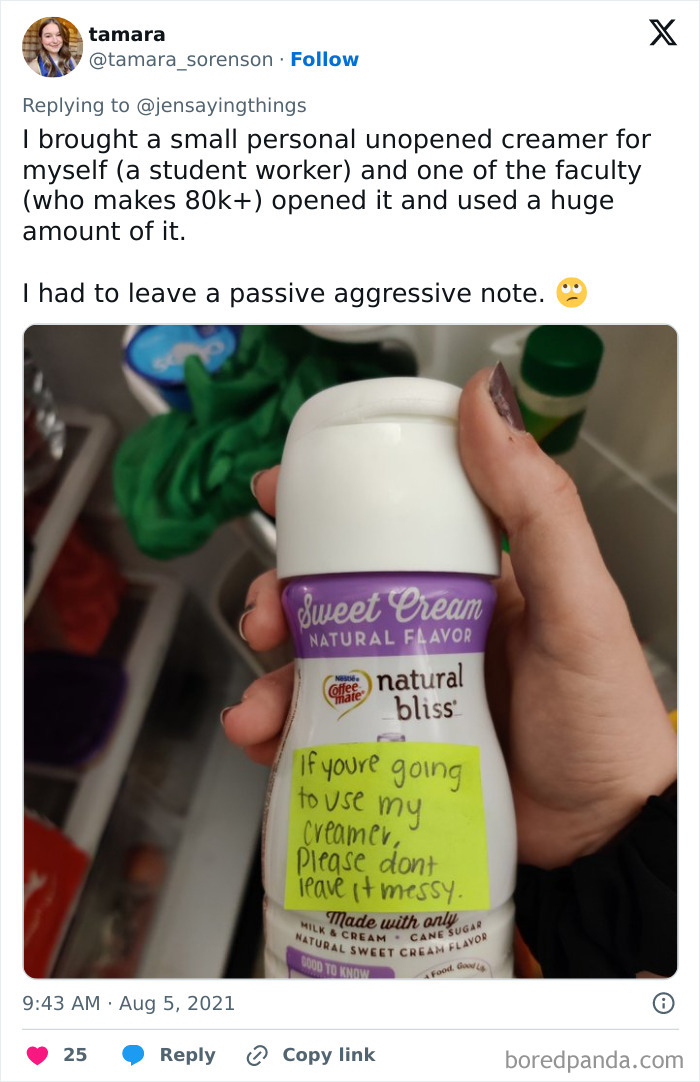 A hand holds a creamer bottle with a passive-aggressive note for an office food thief who used an unopened personal creamer.