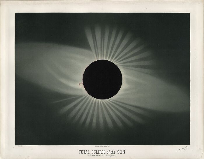 A detailed historical solar eclipse photo with distinct light rays, an extraordinary capture making history.