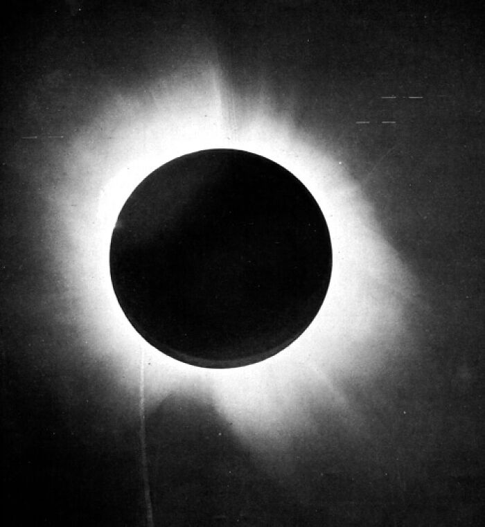 A black and white historical solar eclipse photo, showcasing the glowing corona, an extraordinary sight.