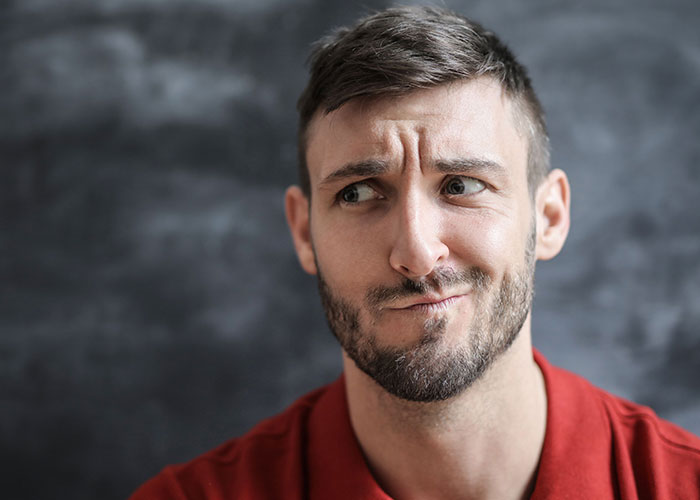 Man with a confused expression, reflecting on a worst first date with women.