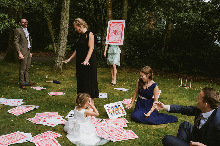 People playing with oversized cards outdoors, a whimsical scene from the Edge Street Photography Awards.