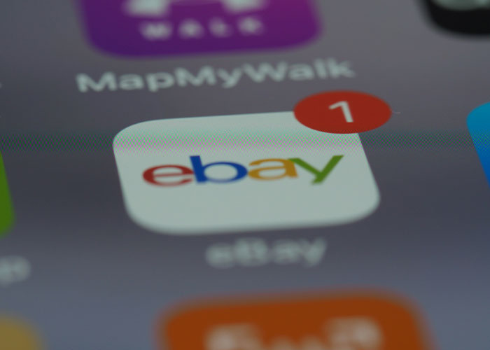 Close-up of the eBay app icon on a smartphone, showing a notification. eBay karma backfires.