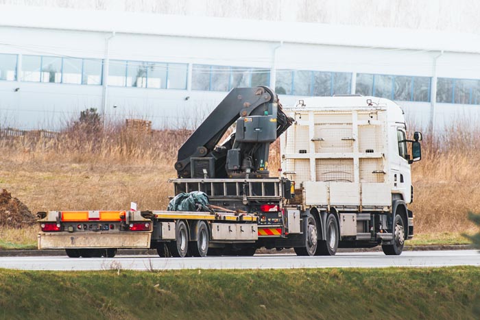 A large white truck on the road, representing dumb work rules related to transportation and logistics.