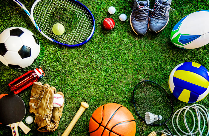 Various sports equipment on green grass, representing kids exercising and physical activity. Various sports equipment on green grass, representing kids exercising and physical activity.