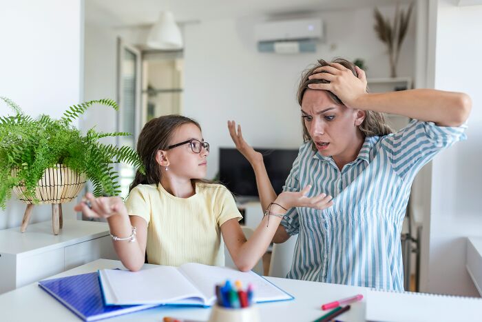 A girl and woman in a home, looking distressed with their hands up, discussing healthy habits.