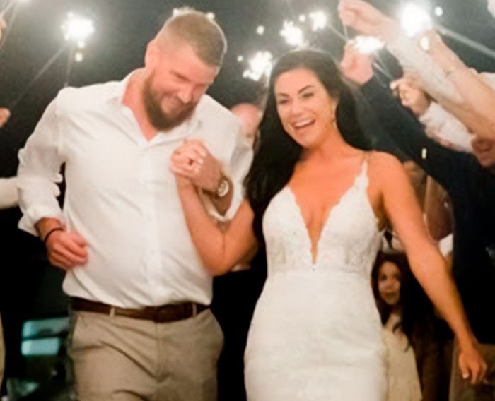 A joyful bride and groom walking hand-in-hand, celebrating their wedding day with sparklers. A joyful bride and groom walking hand-in-hand, celebrating their wedding day with sparklers.