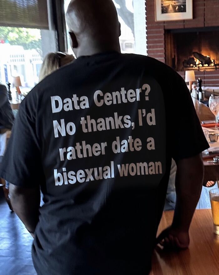 A man wearing an iconic black shirt that says, Data Center? No thanks, I'd rather date a bisexual woman.