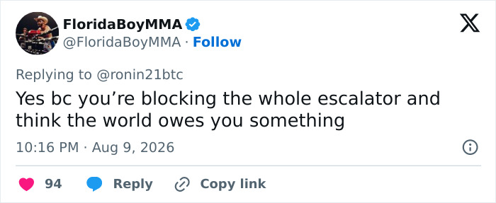 A tweet by user FloridaBoyMMA replying to ronin21btc about blocking the whole escalator. Hero pushes past women filming. A tweet by user FloridaBoyMMA replying to ronin21btc about blocking the whole escalator. Hero pushes past women filming.