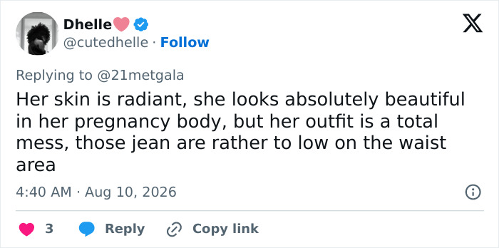Screenshot of a tweet by Dhelle commenting on Anne Hathaway's red carpet maternity outfit, sparking pregnancy theories.