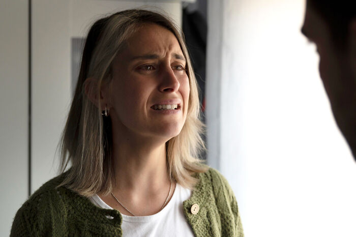A distressed woman crying, highlighting emotional reasons why people walked out without their therapist.