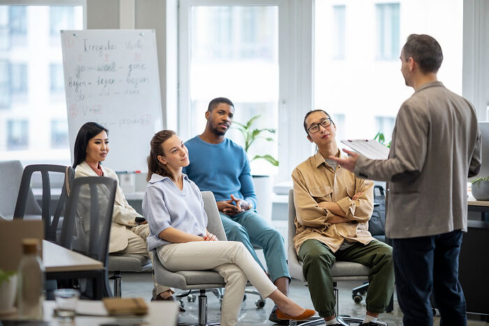 Diverse group of professionals attentively listening to a presentation, related to dumb reasons couples divorce.