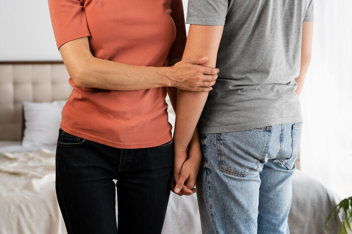 A couple holding hands, symbolizing connection in relationships, which can prevent dumb reasons couples divorce.