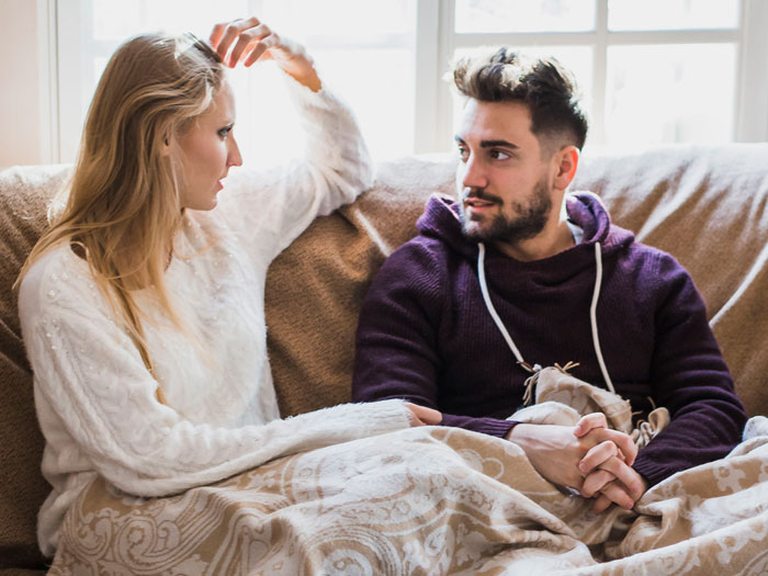 A couple sits on a couch, the woman expressing her feelings to her boyfriend about his family's cruel plan. A couple sits on a couch, the woman expressing her feelings to her boyfriend about his family's cruel plan.