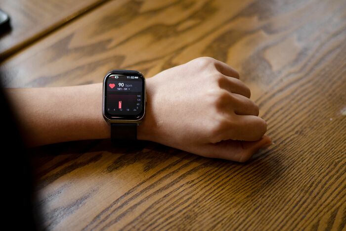 A person wearing a smartwatch displaying heart rate, symbolizing a healthy habit that might be overly glorified.