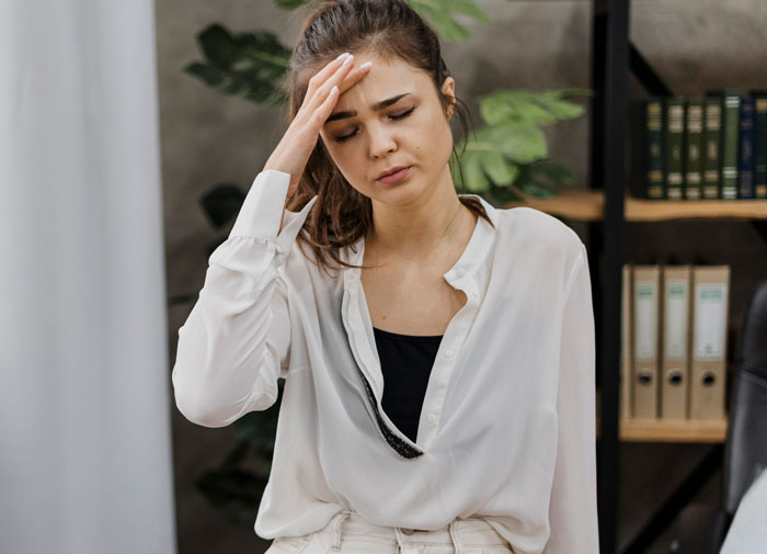 A frustrated bride, hand on forehead, coping with the stress of future MIL trying to take over the wedding. A frustrated bride, hand on forehead, coping with the stress of future MIL trying to take over the wedding.