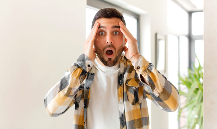 A man with a shocked expression, hands to his head, reacting to his poly wife making his best friend her boyfriend. A man with a shocked expression, hands to his head, reacting to his poly wife making his best friend her boyfriend.