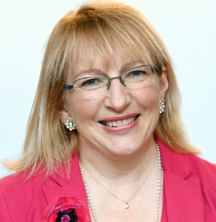 A politician smiles, a key figure in the livestreamed meeting scandal involving her background. A politician smiles, a key figure in the livestreamed meeting scandal involving her background.