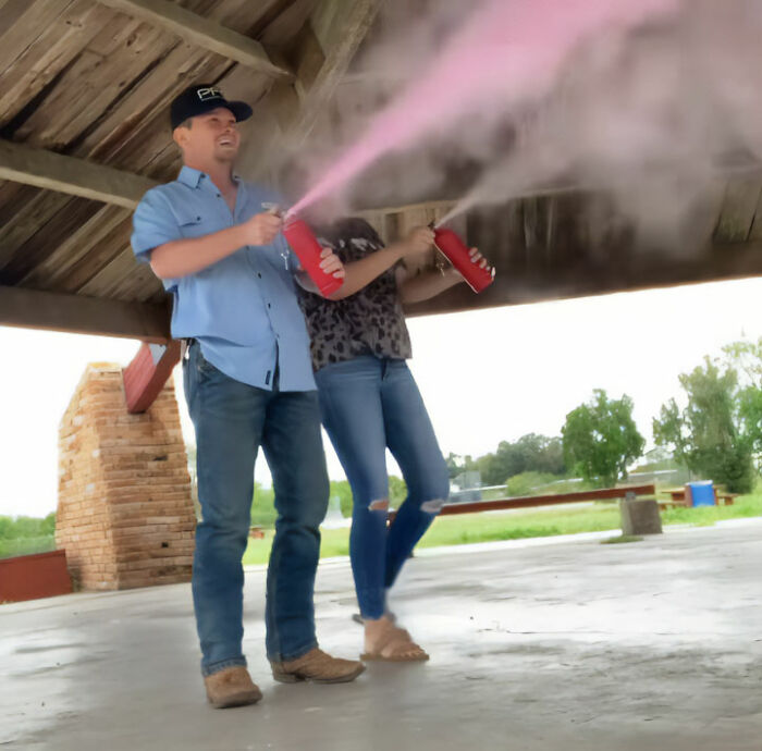 A couple celebrating with pink smoke, after a man accidentally married his cousin. A couple celebrating with pink smoke, after a man accidentally married his cousin.