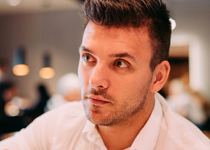 A man with a pensive expression, recalling a worst first date experience.