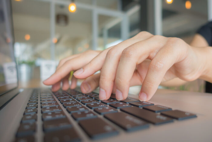 Close-up of hands typing on a laptop keyboard, practicing skills that genuinely changed their lives.