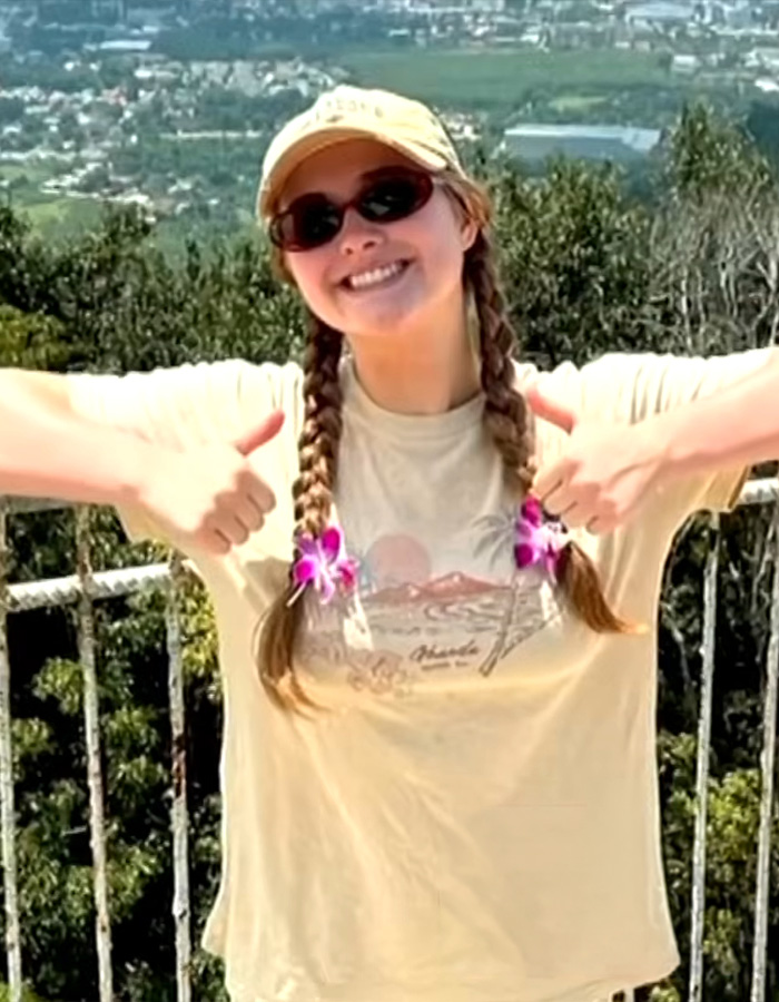 Smiling teen girl giving two thumbs up, contributing to the missing teen mystery.
