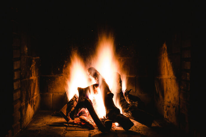 A close-up of a warm fireplace with burning logs, offering a sense of comfort amidst discussions of difficult diagnoses.