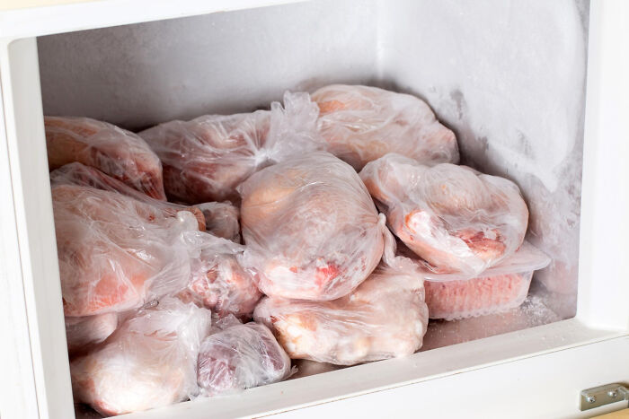 A freezer full of individually wrapped frozen meats, showing the poverty habit of buying in bulk for savings.