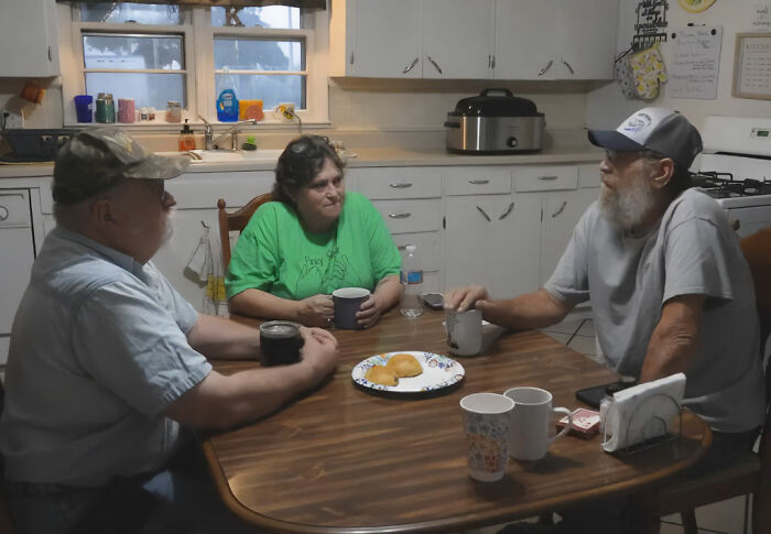 Missouri grandma and two neighbors gathered around a kitchen table, enjoying free breakfasts. Missouri grandma and two neighbors gathered around a kitchen table, enjoying free breakfasts.