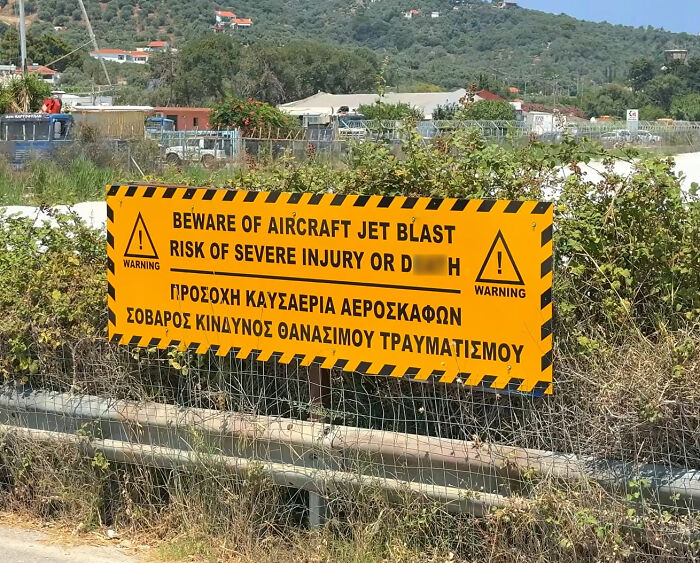 A warning sign about aircraft jet blast near a runway, emphasizing risk of severe injury from the plane's jet engine.