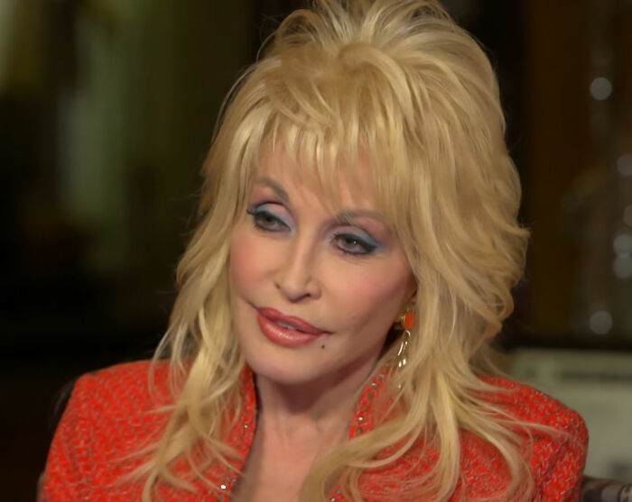 Dolly Parton looking thoughtful during an interview, discussing her sister's revelations about her selfless offer. Dolly Parton looking thoughtful during an interview, discussing her sister's revelations about her selfless offer.