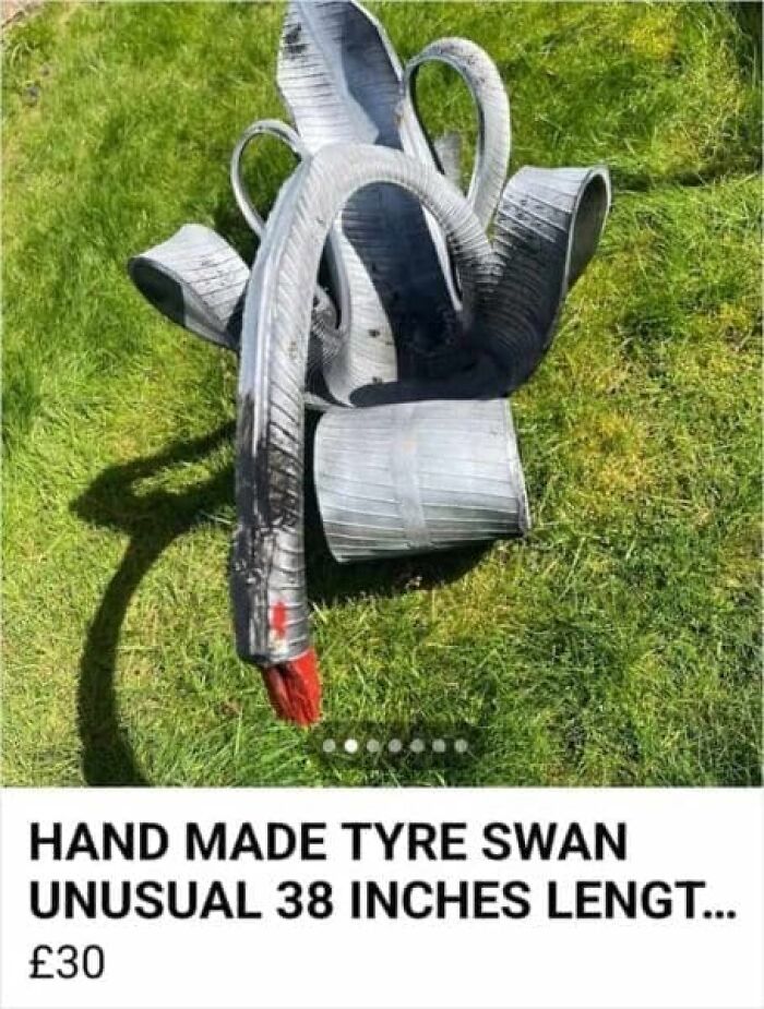 A handmade tire swan sculpture with a red tip on its beak, an unusual item from the weirdest online marketplace screenshots.