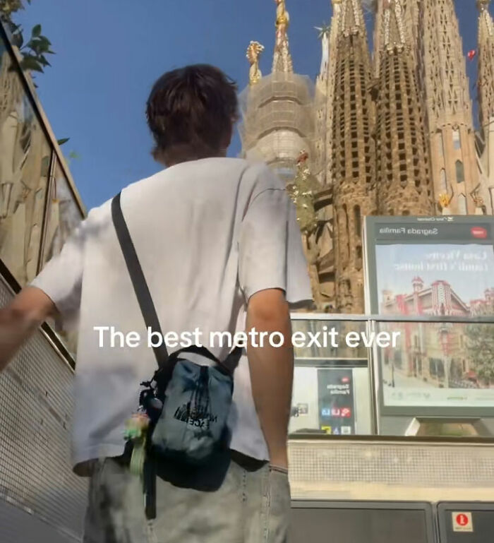 A man pushing past women filming video on a metro station escalator, captioned The best metro exit ever. A man pushing past women filming video on a metro station escalator, captioned The best metro exit ever.